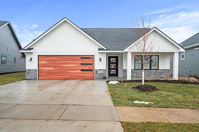 modern inspired farmhouse with a front lawn and a garage