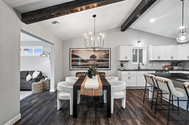 dining room with vaulted ceiling with beams, an inviting chandelier, dark wood-type flooring, and sink