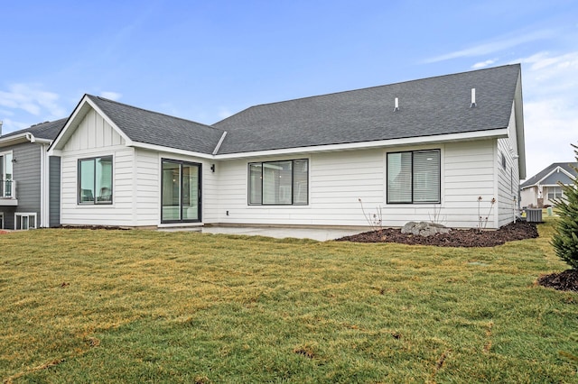 rear view of property featuring central AC unit, a patio area, and a yard