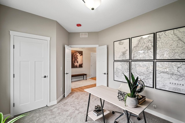 office space with light colored carpet