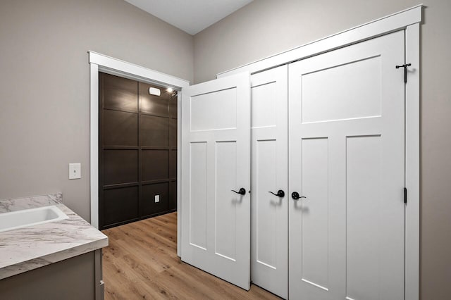 interior space with light hardwood / wood-style floors and sink