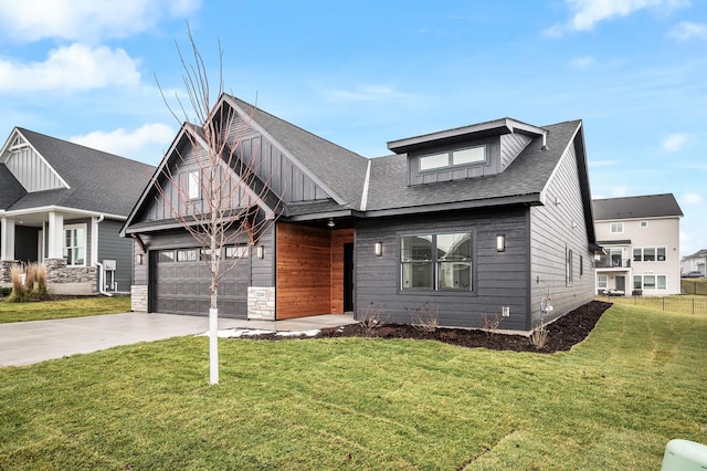 view of front of house with a front yard and a garage