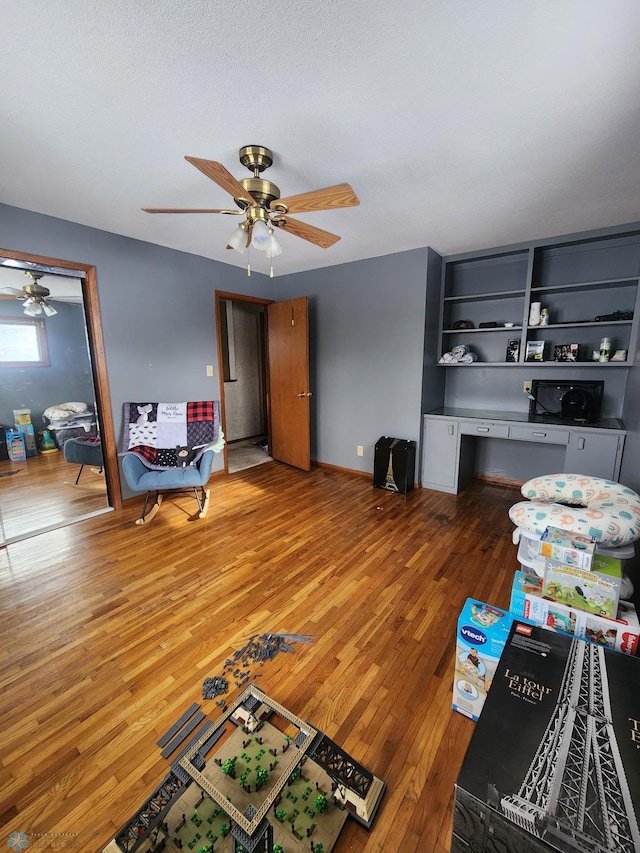 living room featuring hardwood / wood-style floors and ceiling fan