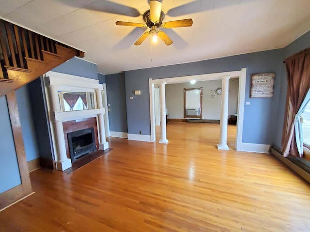 unfurnished living room featuring ornate columns, cooling unit, ceiling fan, a baseboard heating unit, and light hardwood / wood-style floors