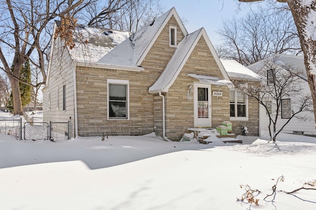 view of front of home featuring a gate, fence, and stone siding