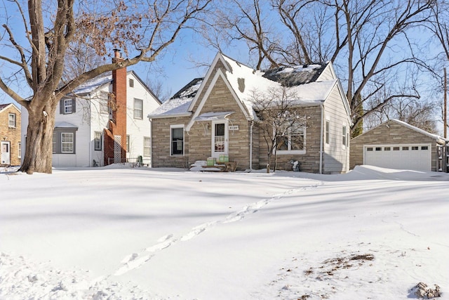 view of front of house with an outdoor structure, stone siding, and a detached garage