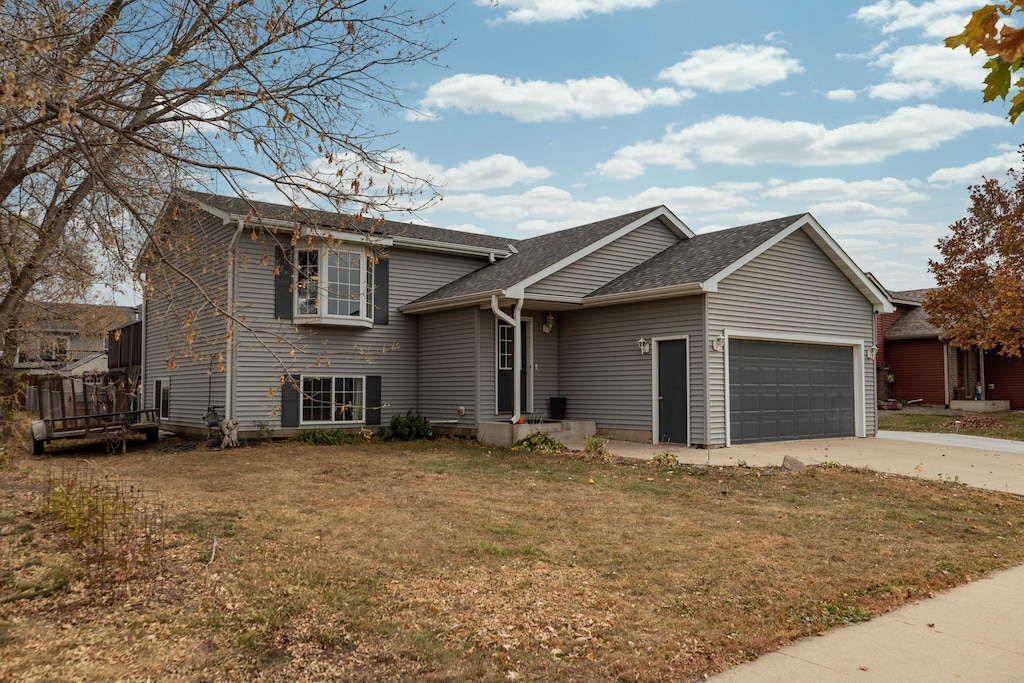 view of front of property with a garage and a front lawn