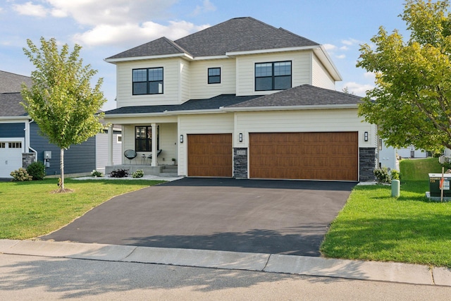 view of front facade with a front yard and a garage