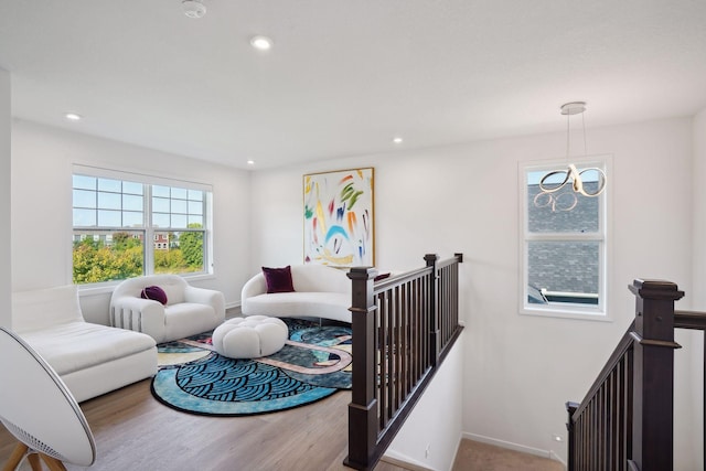 living room featuring hardwood / wood-style flooring and a notable chandelier