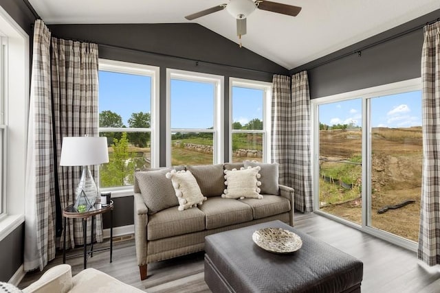 sunroom / solarium with ceiling fan and lofted ceiling