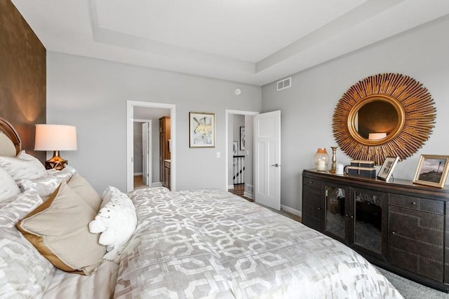 bedroom featuring a raised ceiling