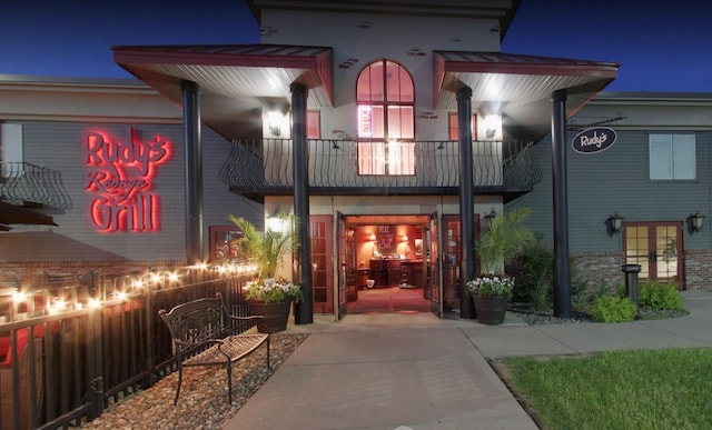 exterior entry at night featuring a balcony