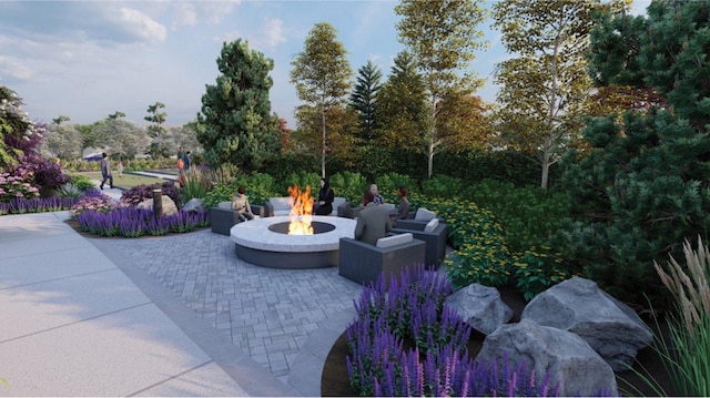 view of property's community featuring an outdoor fire pit and a patio area