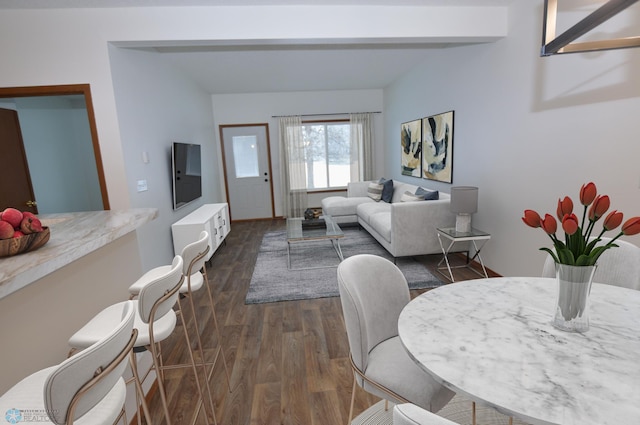 living room with beamed ceiling and dark hardwood / wood-style flooring