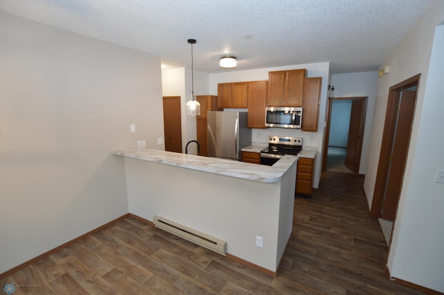 kitchen with kitchen peninsula, a textured ceiling, stainless steel appliances, baseboard heating, and hanging light fixtures