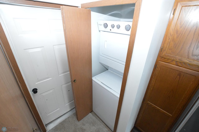 laundry room featuring stacked washer / dryer