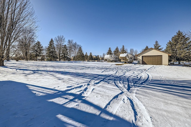 yard layered in snow with a garage