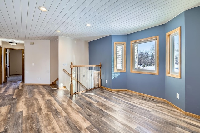 unfurnished room featuring wood ceiling and dark hardwood / wood-style flooring