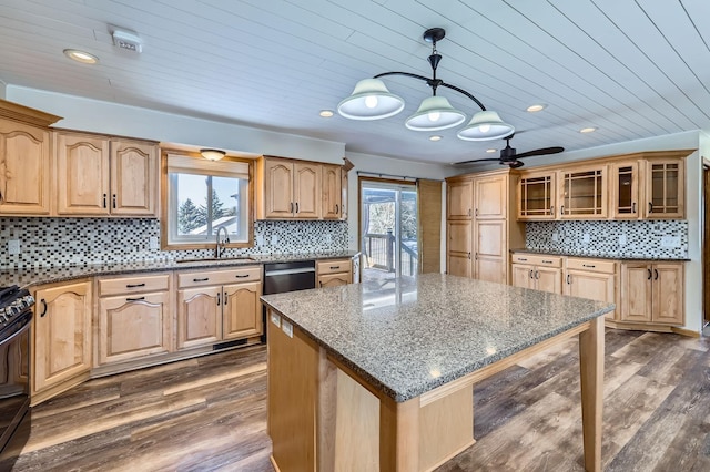 kitchen with sink, a kitchen island, a wealth of natural light, and pendant lighting