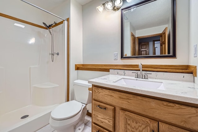 bathroom with toilet, tile patterned flooring, walk in shower, and vanity