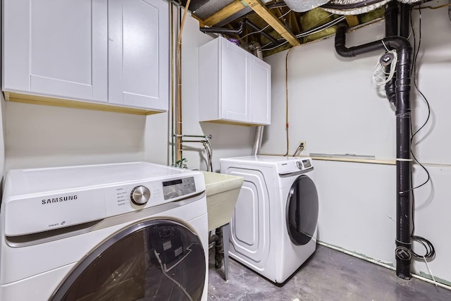 clothes washing area with cabinets and independent washer and dryer