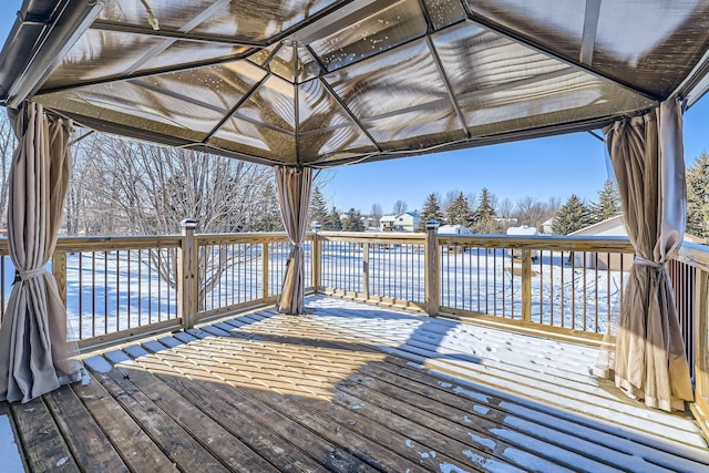 wooden deck featuring a gazebo and a water view