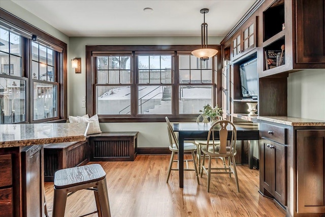 dining room with light wood-type flooring and baseboards