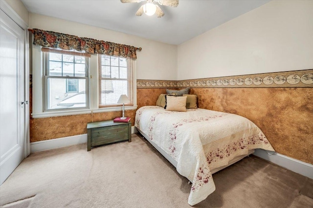 carpeted bedroom with wallpapered walls and baseboards