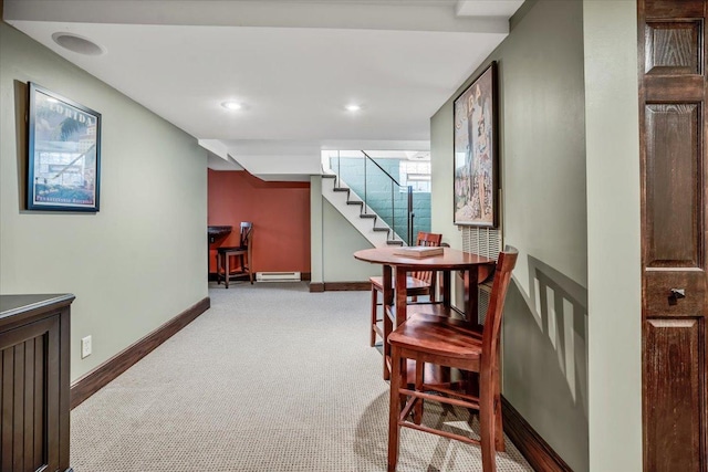 hallway featuring recessed lighting, a baseboard heating unit, baseboards, stairway, and carpet