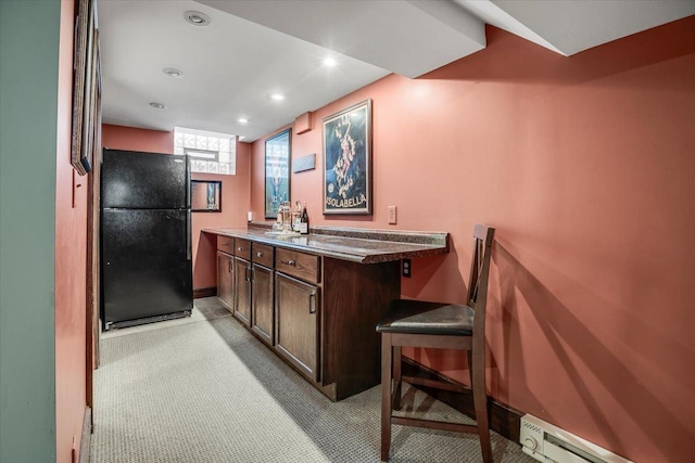 bar featuring recessed lighting, a baseboard radiator, light carpet, and freestanding refrigerator