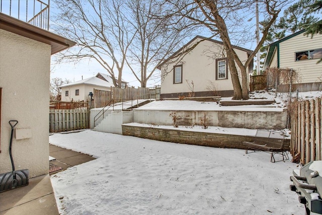 snowy yard featuring fence