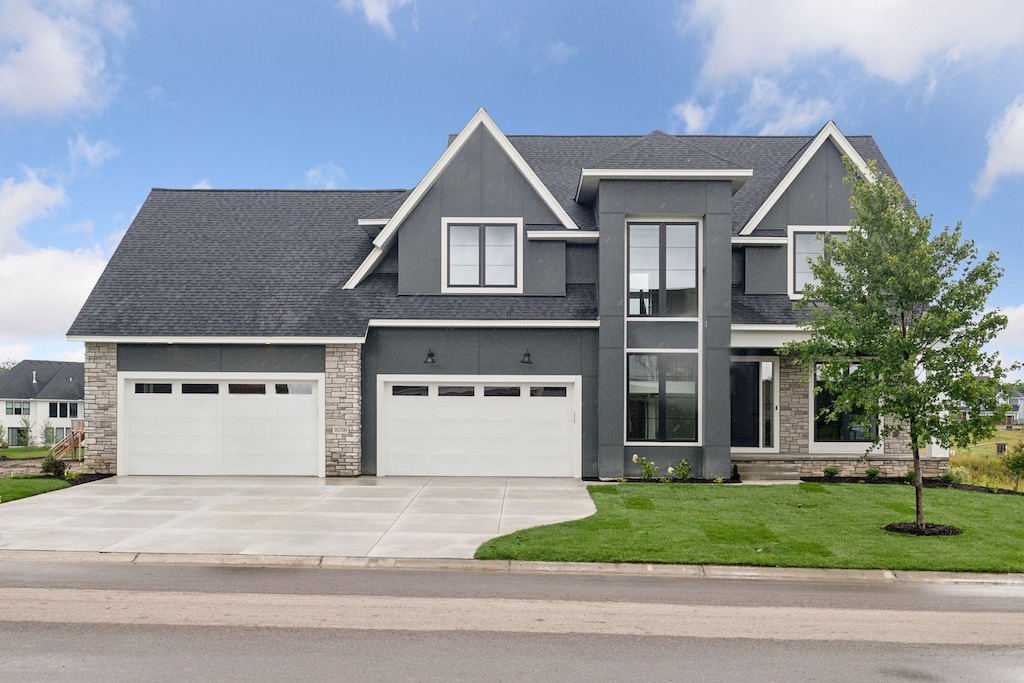 view of front of house with a garage and a front lawn