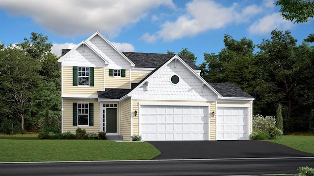 view of front of home with a front yard and a garage