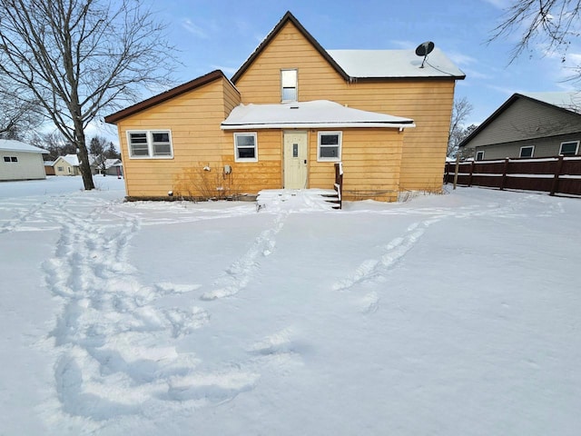 view of snow covered back of property