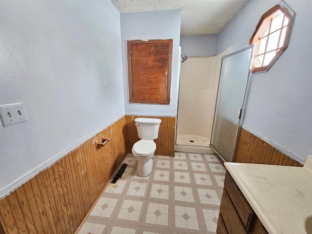 bathroom featuring toilet, an enclosed shower, and wooden walls