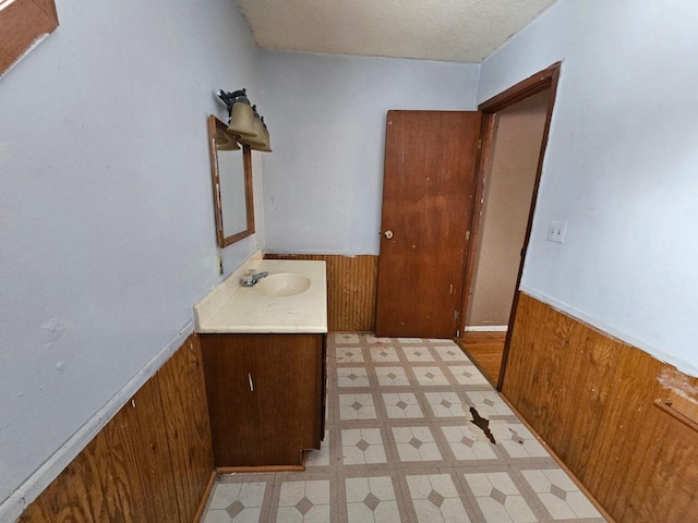 bathroom with wood walls and vanity