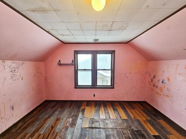 additional living space featuring dark hardwood / wood-style flooring and lofted ceiling