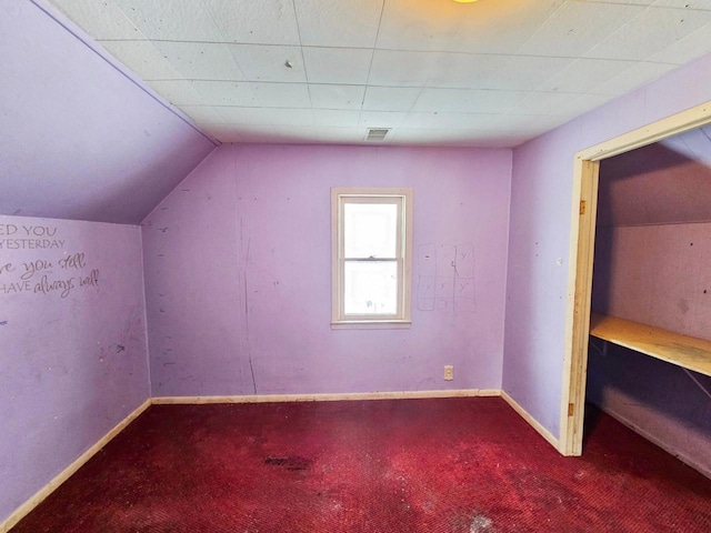 additional living space with carpet and vaulted ceiling