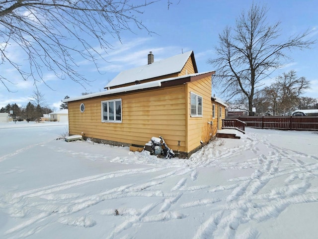 snow covered property with a wooden deck