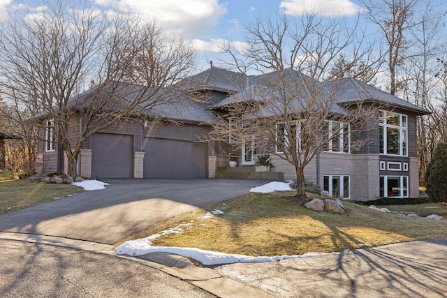 3529 Green Ridge Rd, Minnetonka, MN 55305 - prairie-style house featuring asphalt driveway, a front lawn, brick siding, and a garage