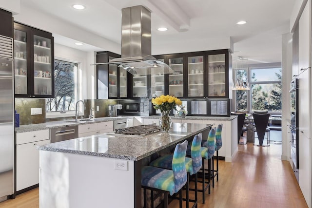 3529 Green Ridge Rd, Minnetonka, MN 55305 - kitchen featuring stainless steel appliances, decorative backsplash, light wood finished floors, glass insert cabinets, and white cabinets