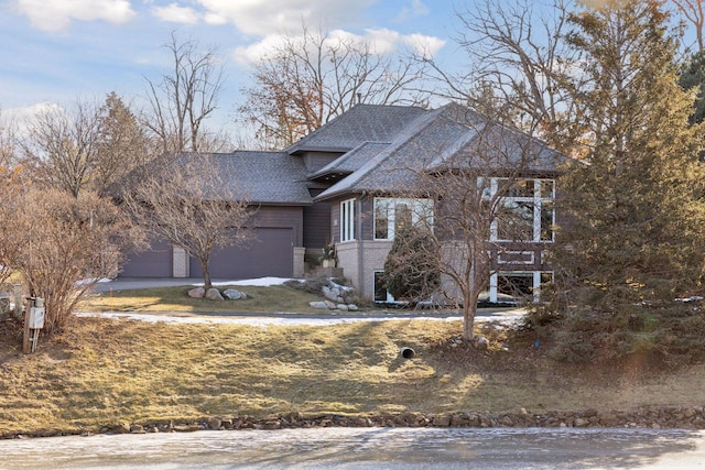 3529 Green Ridge Rd, Minnetonka, MN 55305 - view of front of house featuring roof with shingles, an attached garage, and brick siding