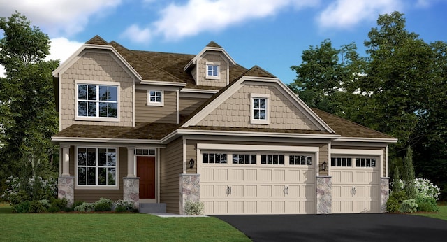 craftsman house with a front yard and a garage