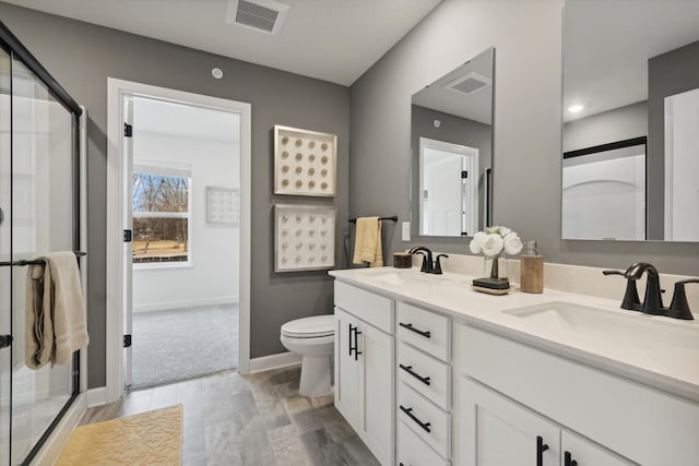 bathroom with wood-type flooring, vanity, toilet, and a shower with door