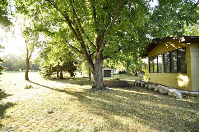 view of yard with an outbuilding and a garage