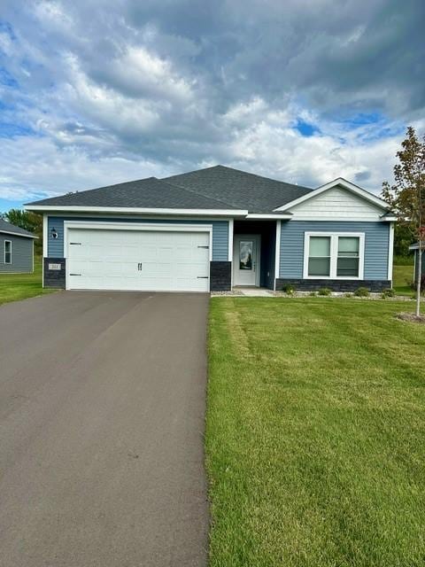 ranch-style house with a garage and a front lawn