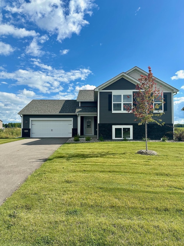 view of front of house featuring a garage and a front yard