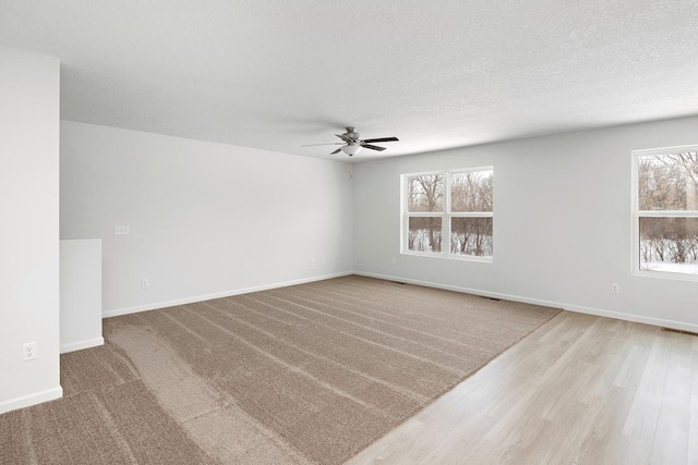 empty room featuring ceiling fan and a textured ceiling