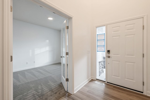 foyer entrance with hardwood / wood-style flooring