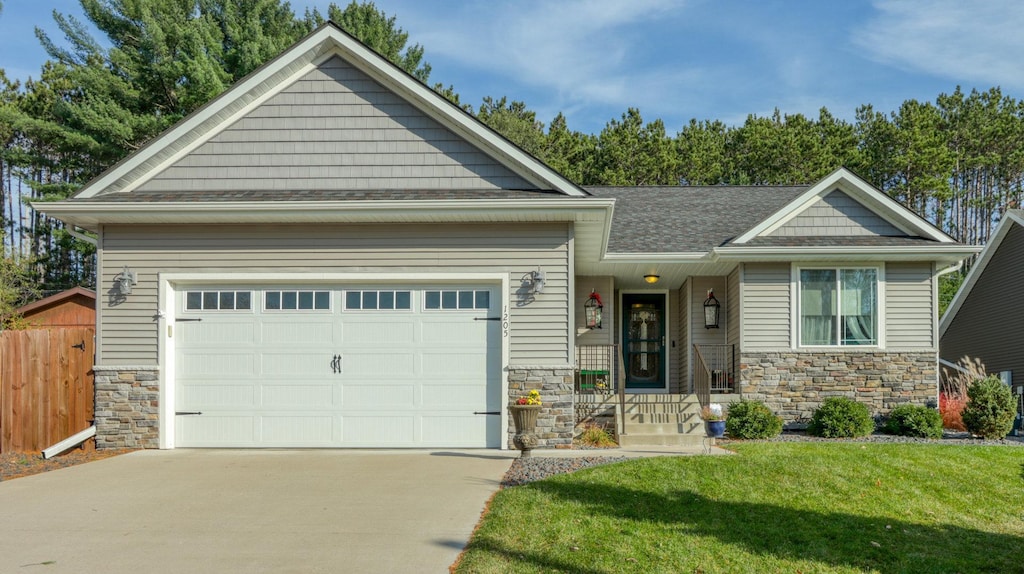 craftsman-style home with a garage and a front lawn